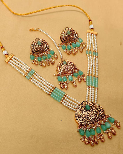 Premium Matt Gold Polish Necklace Set with Pearls & Multi-Stone Detailing With Earrings and Maang Tikka