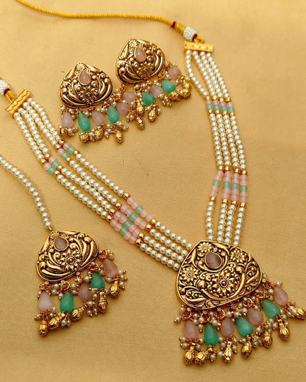 Premium Matt Gold Polish Necklace Set with Pearls & Multi-Stone Detailing With Earrings and Maang Tikka